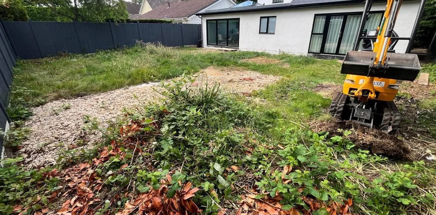 Before: overgrown garden being cleared with a mini digger